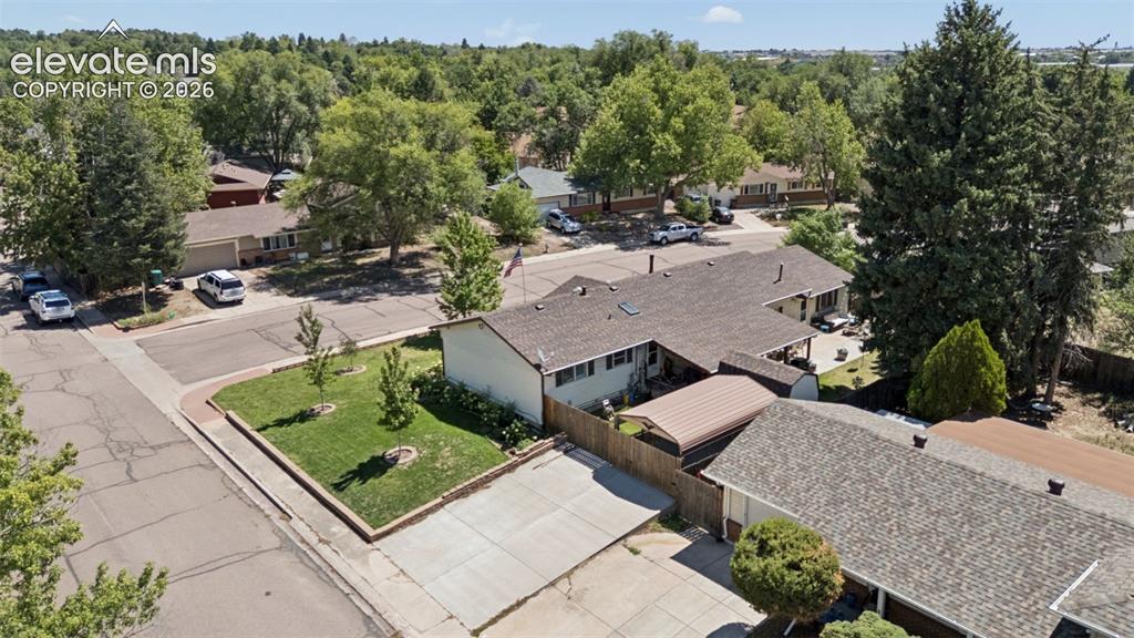 Image 3 of 48: Corner lot with side driveway and gated carport parking