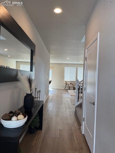 Image 3 of 6: Corridor featuring wood finished floors, recessed lighting, and a textured 