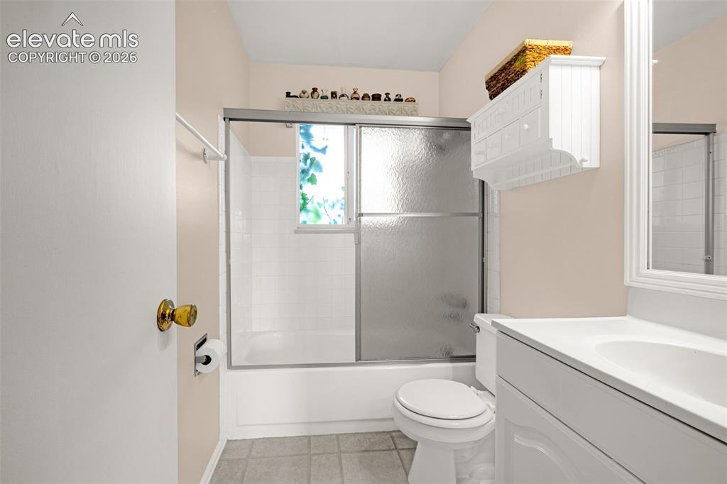 Image 10 of 32: Full bathroom on the upper level has tile flooring, large window for lots o