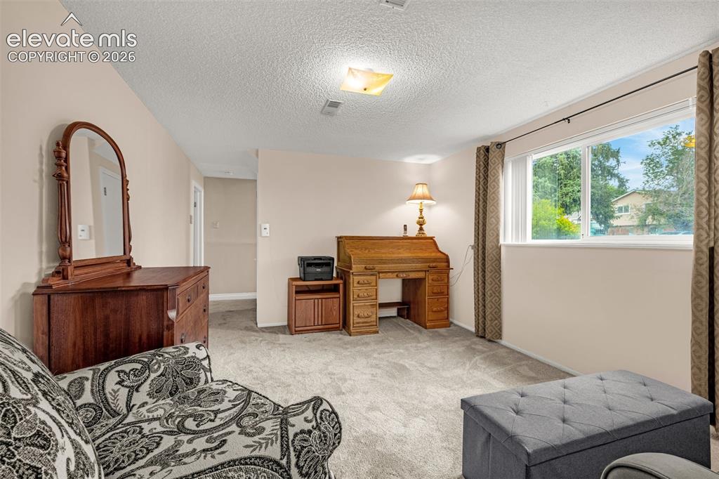 Image 12 of 32: Family room with large picture window allows an abundance of light to flow 