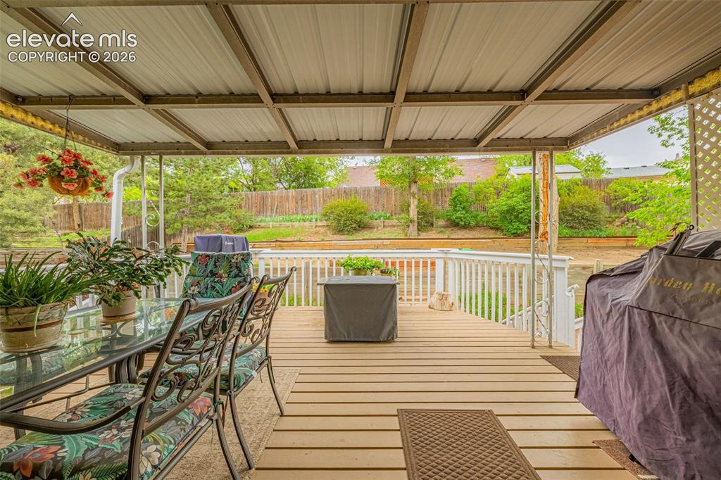 Image 18 of 32: The covered back deck offers plenty of room for gatherings and celebrations