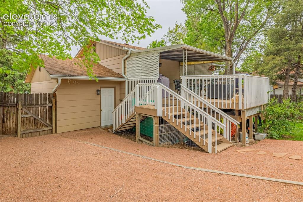 Image 20 of 32: Door from garage gives you easy access to the deck and backyard area. 