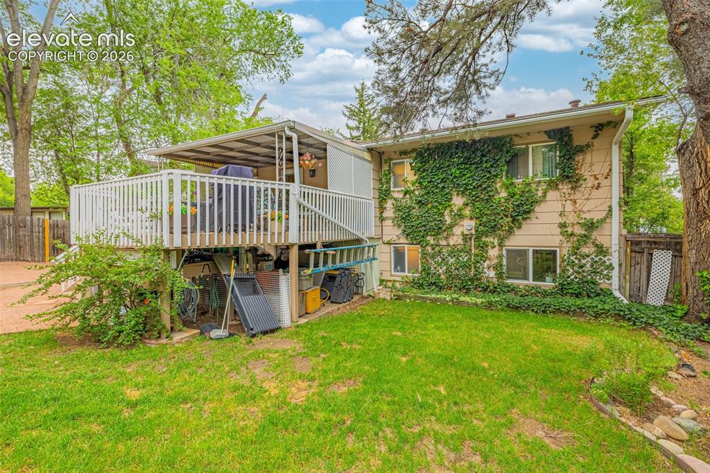 Image 21 of 32: Fully fenced yard offers grass area with multi-zoned sprinkler system, and 
