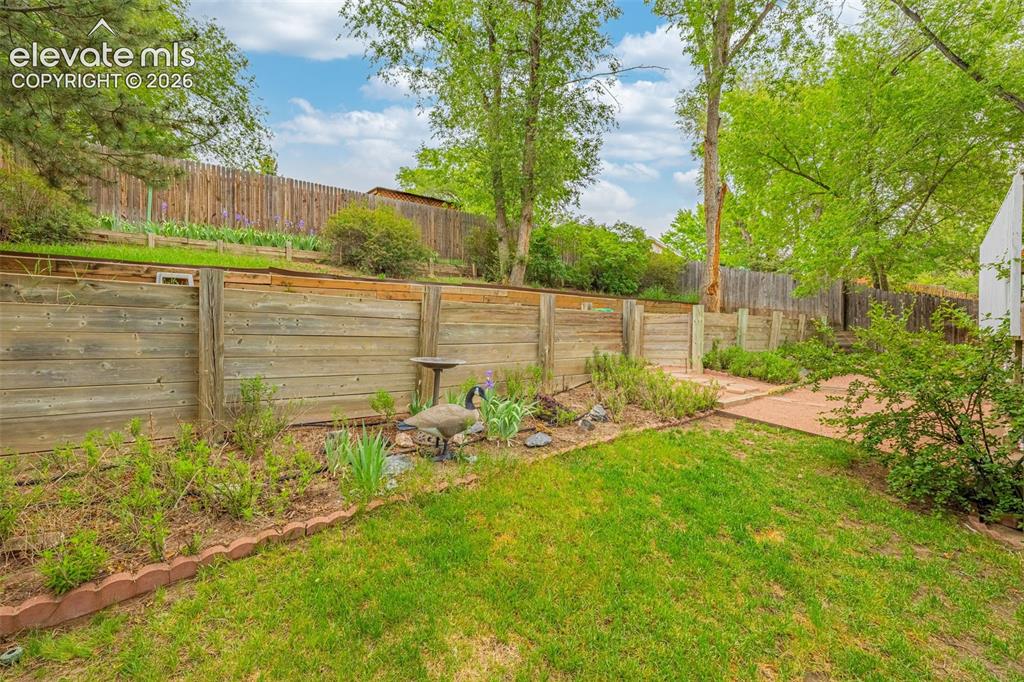 Image 23 of 32: Large fenced yard is perfect for gardening and offer lots of shades afforde