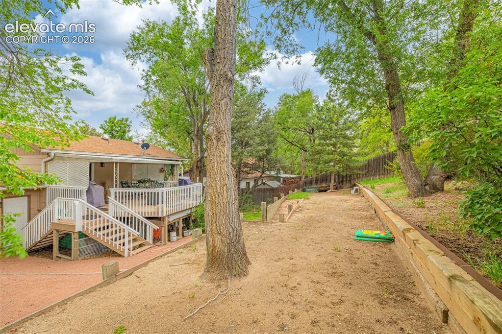 Image 25 of 32: Tiered backyard allows for additional space and privacy.  Grow a garden, ad