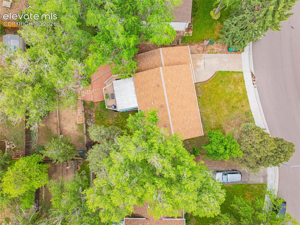 Image 28 of 32: Aerial view of the home and surrounding trees offering plenty of shade and 
