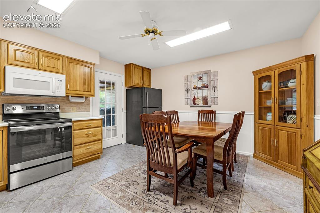 Image 3 of 32: Bright and roomy with wainscoting details makes this kitchen perfect for ge