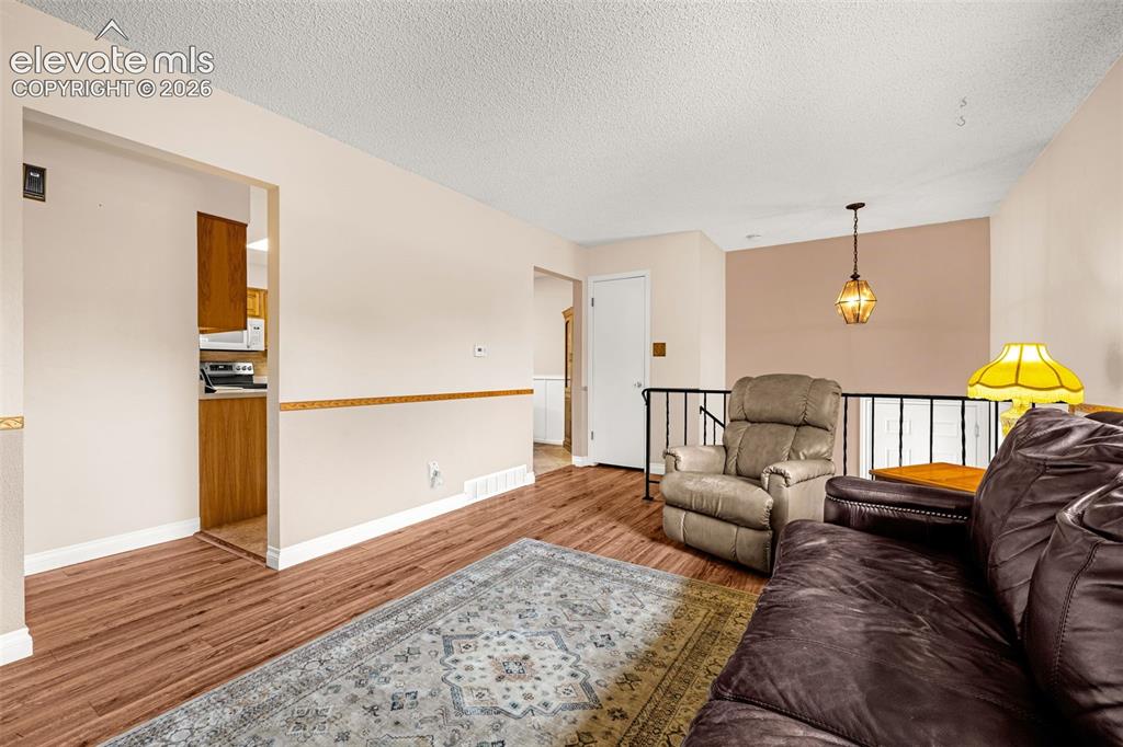 Image 6 of 32: Laminate flooring helps keep the home clean, the coat closet was converted 