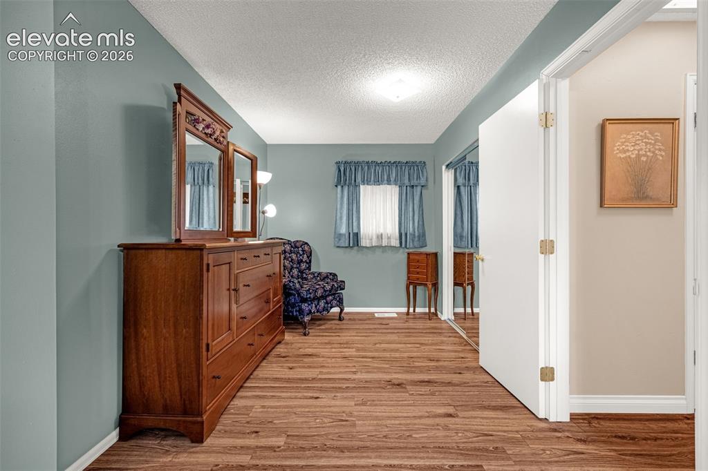Image 8 of 32: Primary has ample room for a sitting/dressing area and large walk-in closet