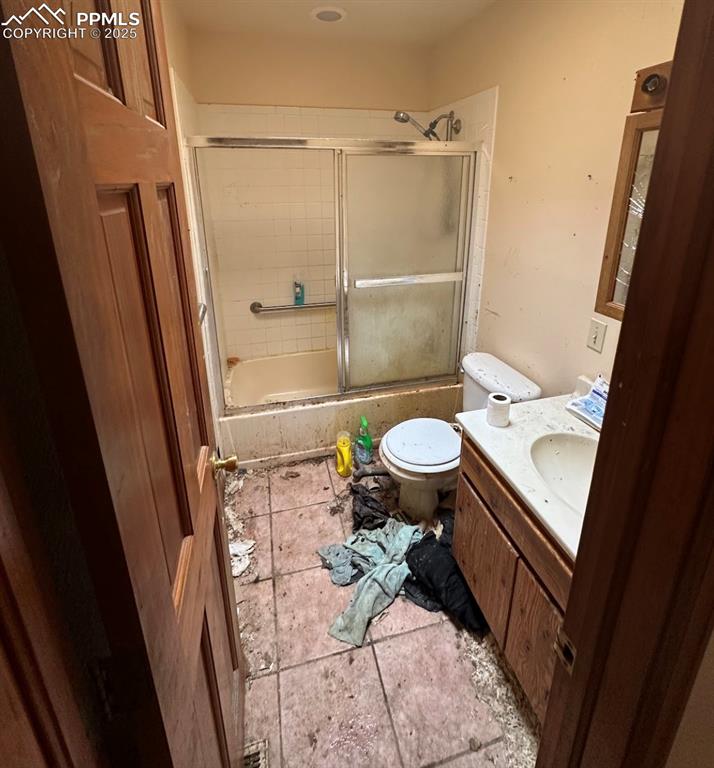 Image 19 of 36: Full bathroom with tiled shower / bath, vanity, and light tile patterned fl