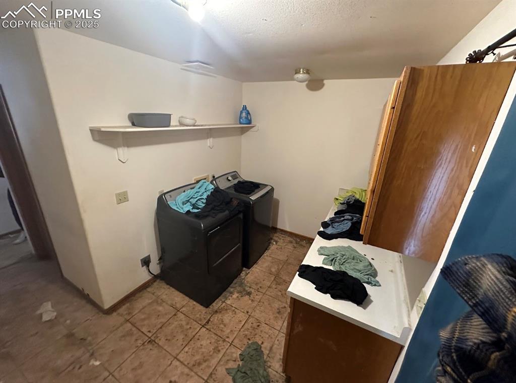 Image 21 of 36: Kitchen featuring washer and dryer and light countertops
