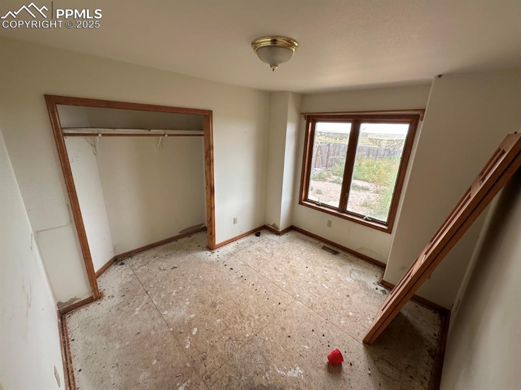 Image 23 of 36: Unfurnished bedroom with a closet and baseboards