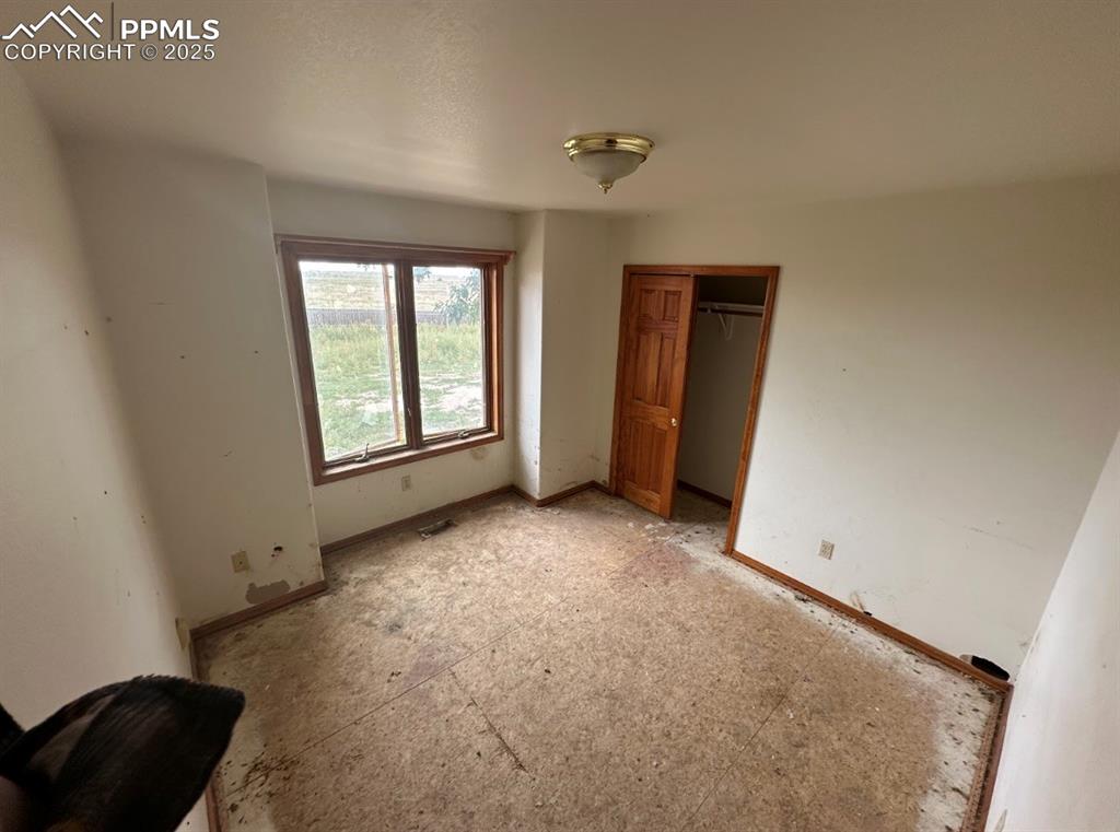 Image 24 of 36: Unfurnished bedroom with a closet and baseboards