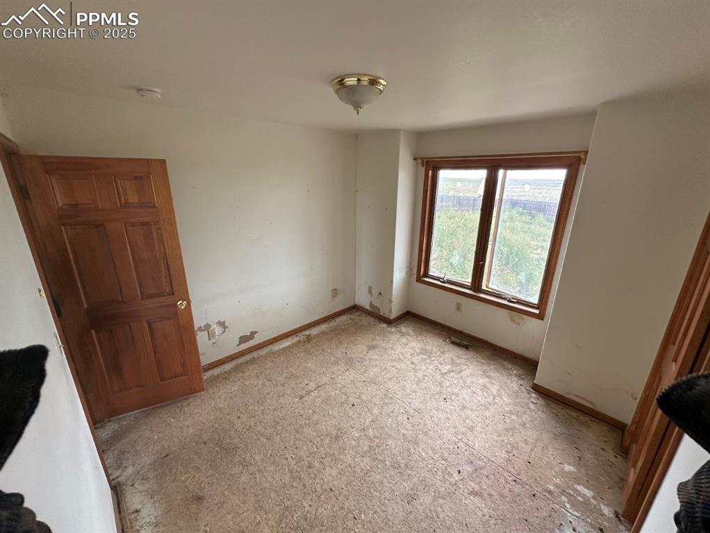 Image 25 of 36: Unfurnished bedroom with baseboards