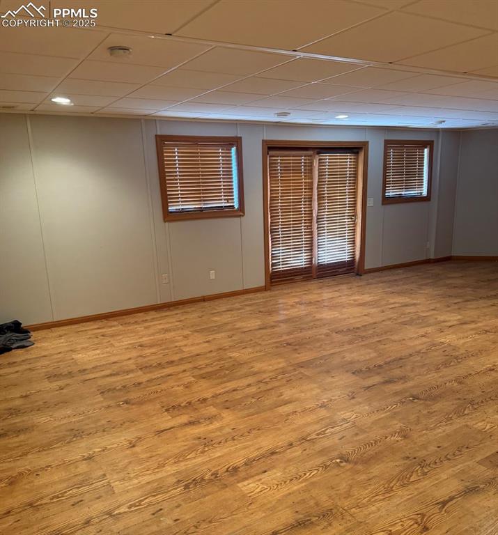Image 34 of 36: Spare room with a paneled ceiling and light wood-style flooring