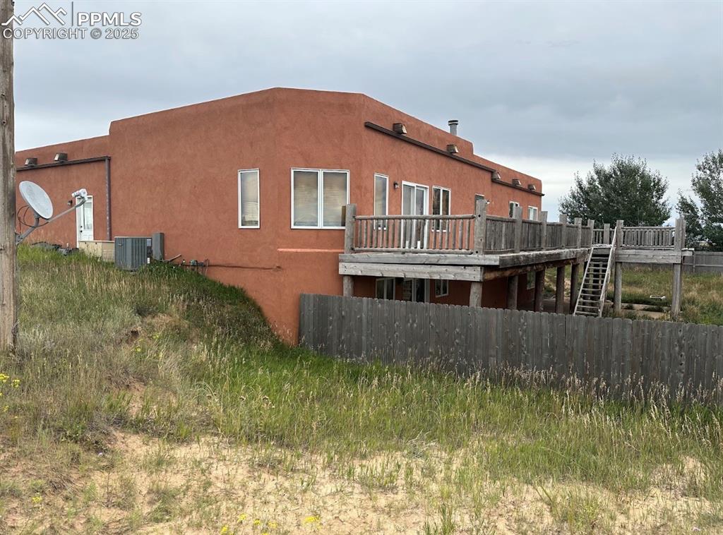 Image 4 of 36: Back of house with a deck, stairs, and stucco siding