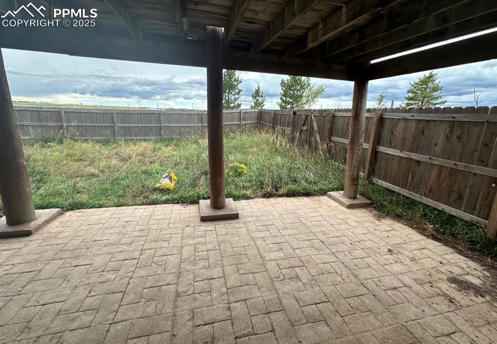 Image 6 of 36: Fenced backyard featuring a patio area