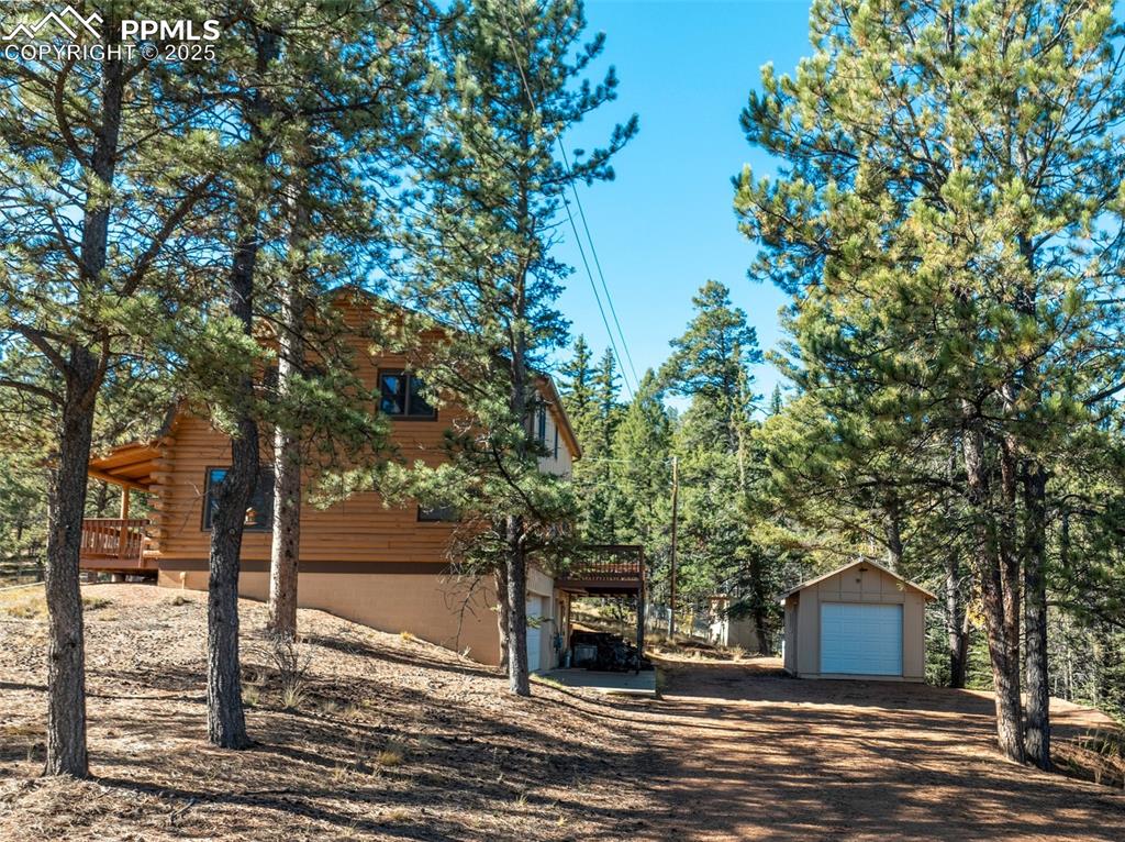 Image 16 of 50: Garage, parking and storage shed