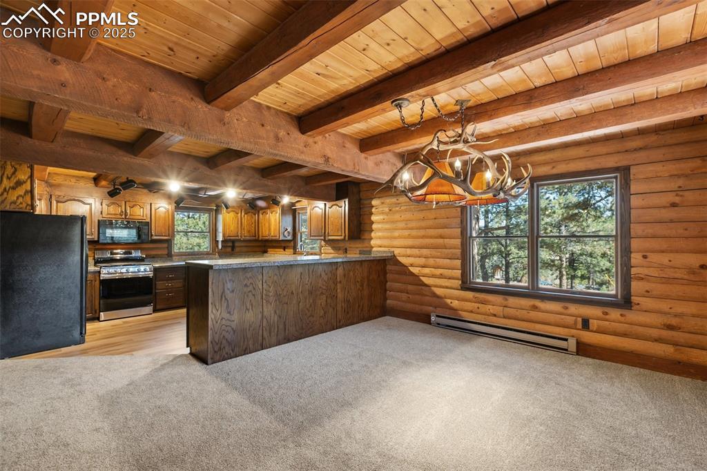 Image 22 of 50: View from dining room to kitchen, New carpet and LVT. New gas range. All ca