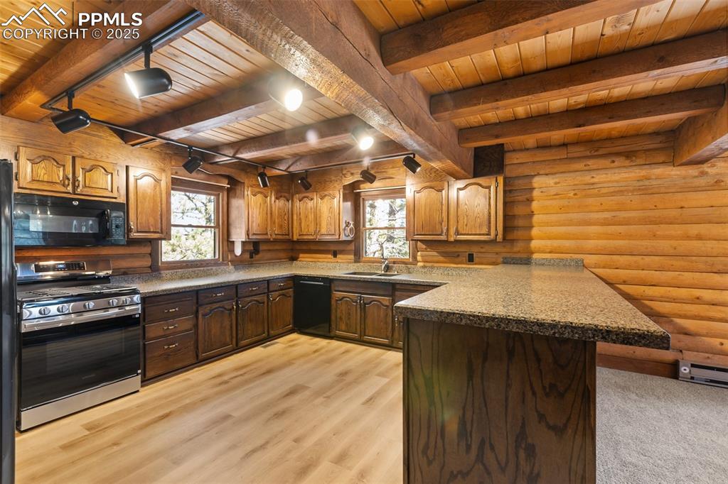 Image 25 of 50: All new LVT flooring, cabinets have been refinished, brand new gas range.
