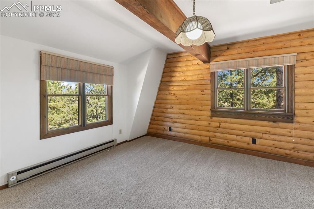 Image 38 of 50: Large second bedroom on upper level.  New paint and carpet.