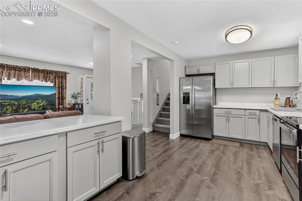 Image 5 of 21: Hand-through window from living room to kitchen