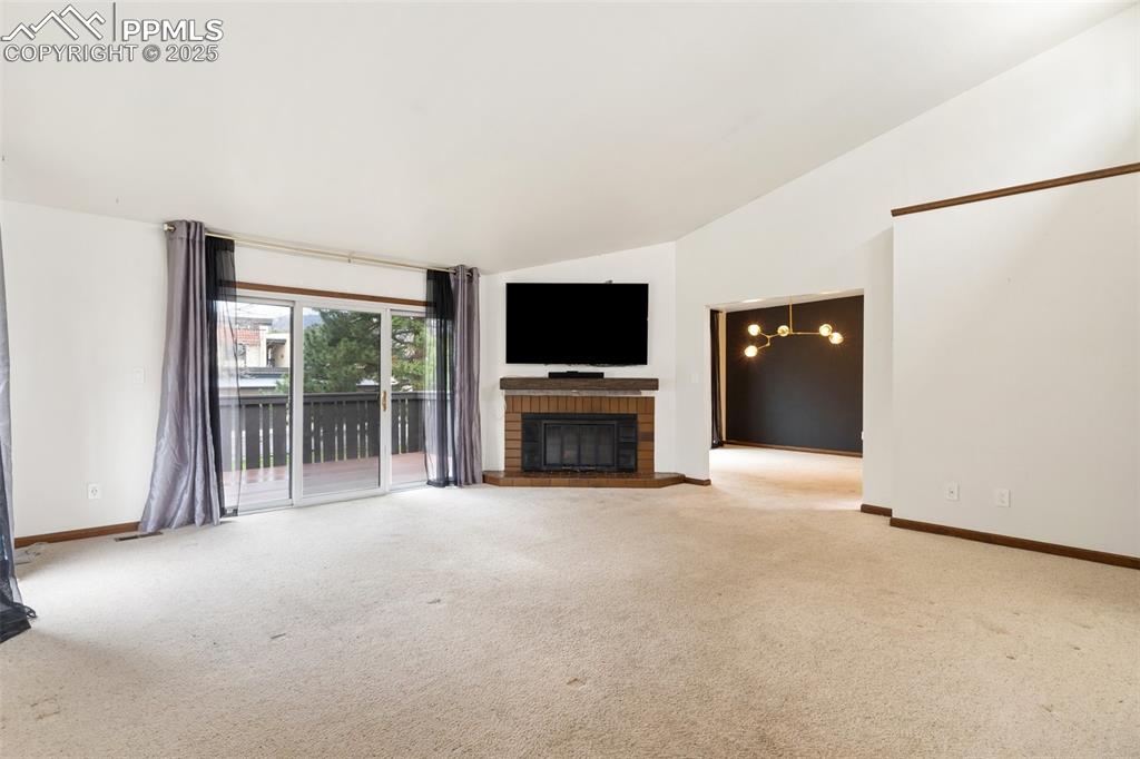 Image 7 of 23: Features a cozy fireplace and flat screen, plus a slider walk out to a moun