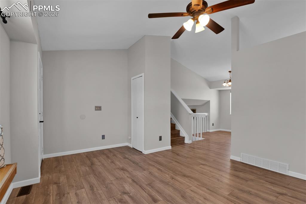 Image 11 of 42: Opposite view of living room, entry and stairs. 
