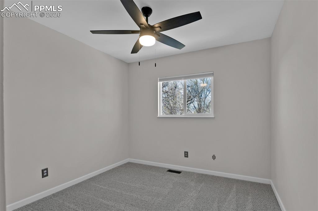 Image 24 of 42: Secondary Bedroom #1 with new paint and new carpet.