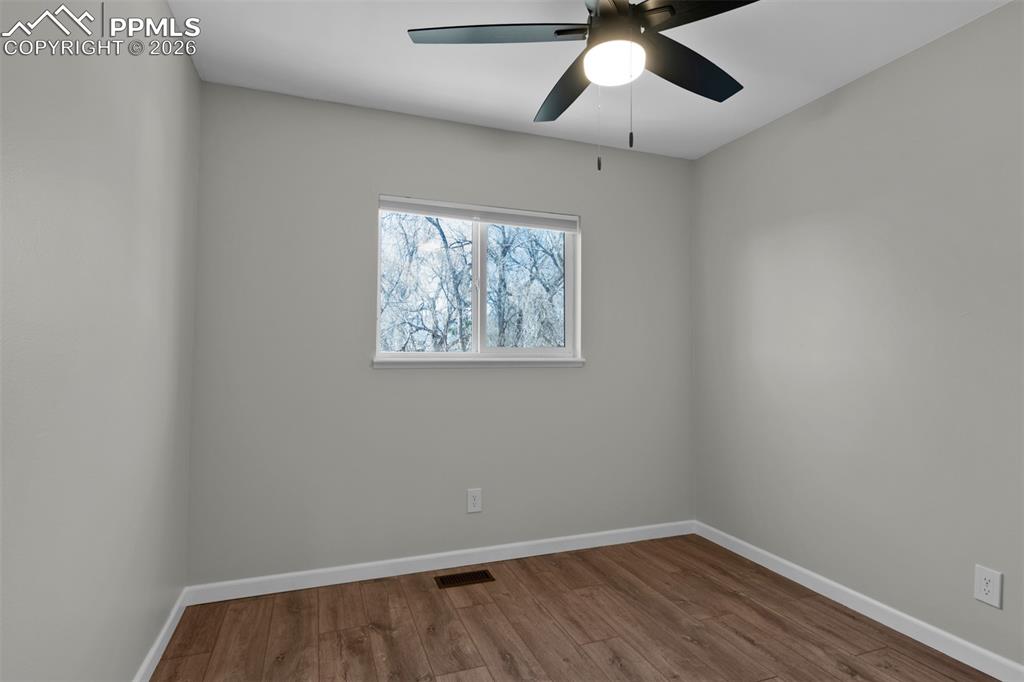 Image 27 of 42: Secondary Bedroom #2 with fresh paint and updated LVP Flooring. 