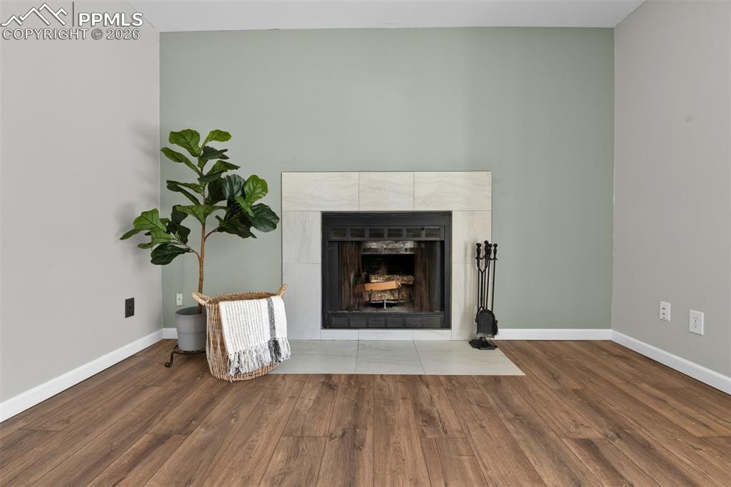 Image 31 of 42: Family room has a wood burning fireplace for cozy winters. 