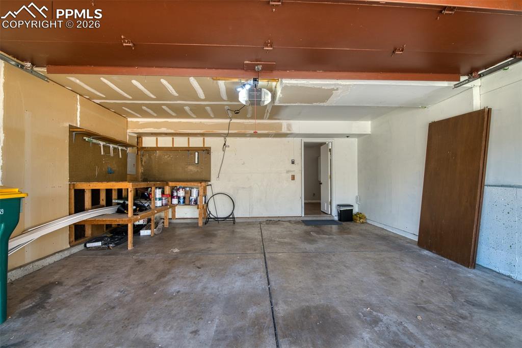 Image 41 of 42: Full size 2 car garage with built-in workbench area. 