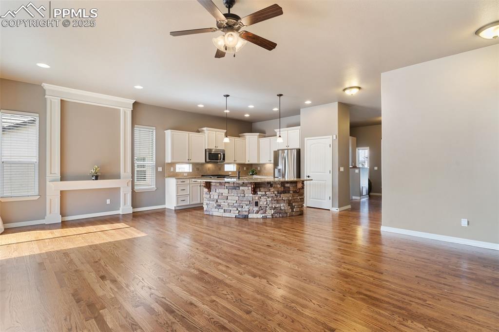 Image 10 of 27: Unfurnished living room with ceiling fan, light wood-type flooring, and rec