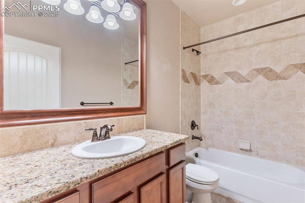 Image 20 of 27: Full bathroom featuring shower combination and vanity