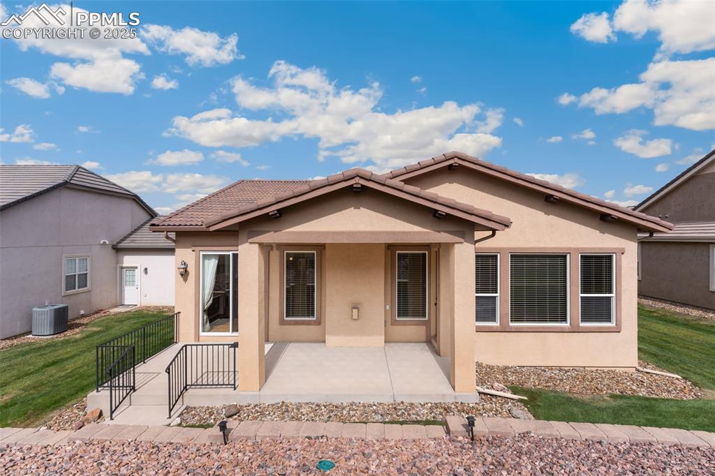 Image 27 of 27: Ranch-style house featuring a patio, stucco siding, and a front lawn