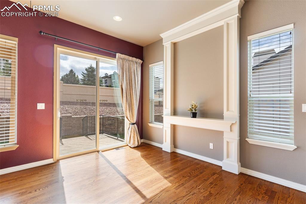 Image 6 of 27: Doorway to outside featuring wood finished floors and baseboards