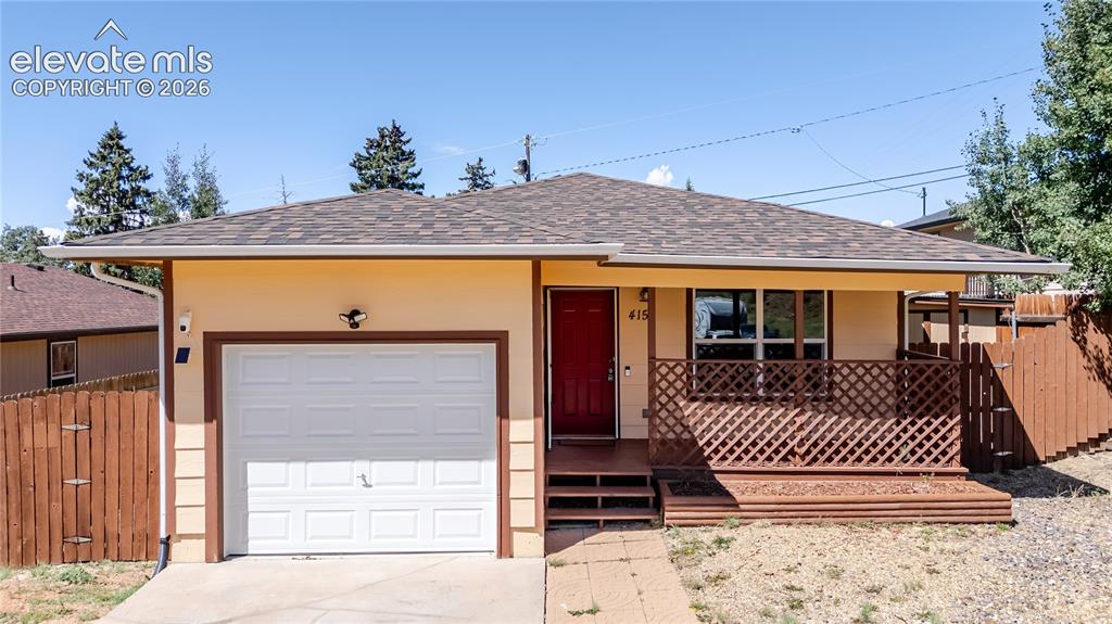 Caption: Single-story residence featuring a covered front porch with lattice detailing, an attached garage, a