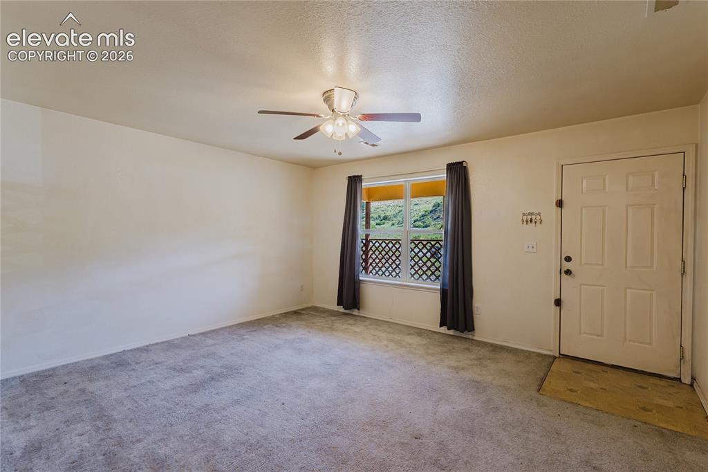 Image 10 of 27: Living Room as you enter front door, overlooks covered front porch