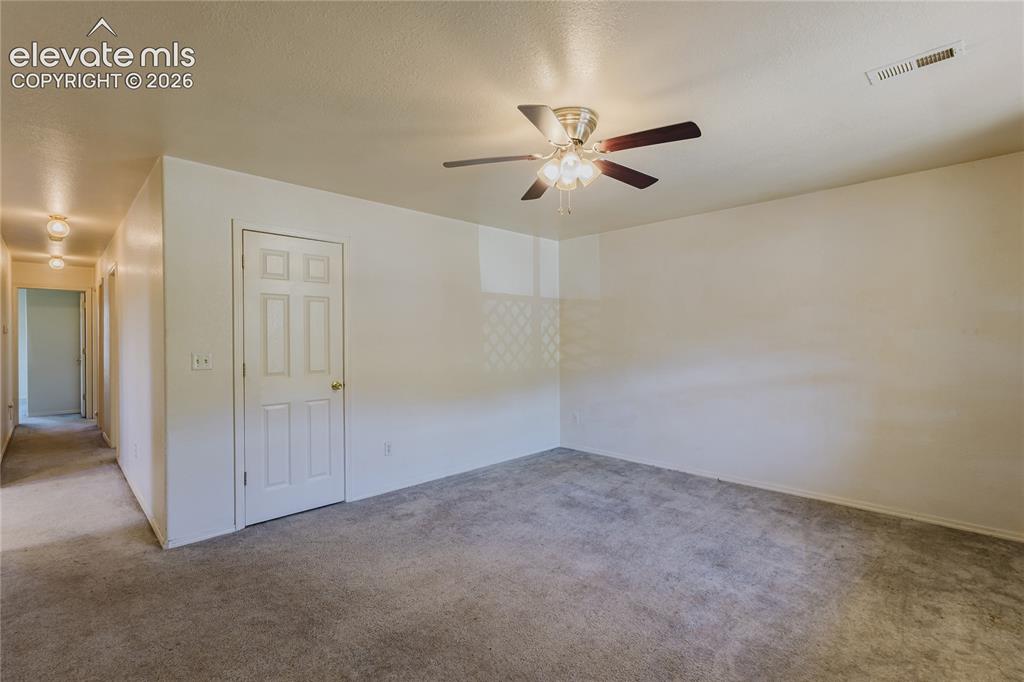 Image 11 of 27: Living room with coat closet