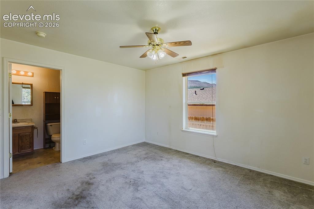 Image 17 of 27: Primary bedroom with ensuite full bathroom