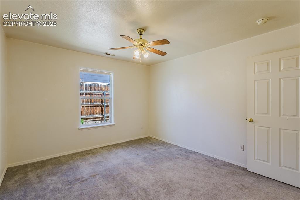 Image 21 of 27: 2nd bedroom on right, window to side yard and closet