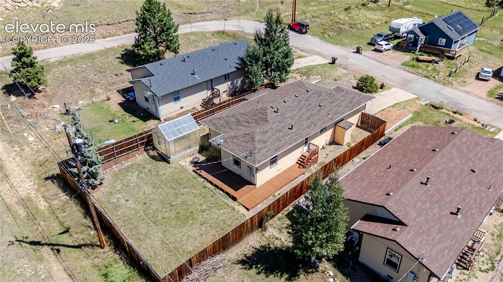 Image 6 of 27: Aerial of backyard, side and back ground level decking