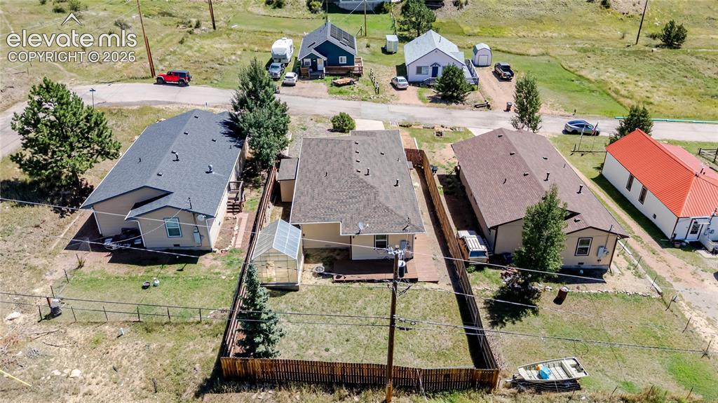 Image 8 of 27: Aerial of home from back alley with double gate access to backyard for boat
