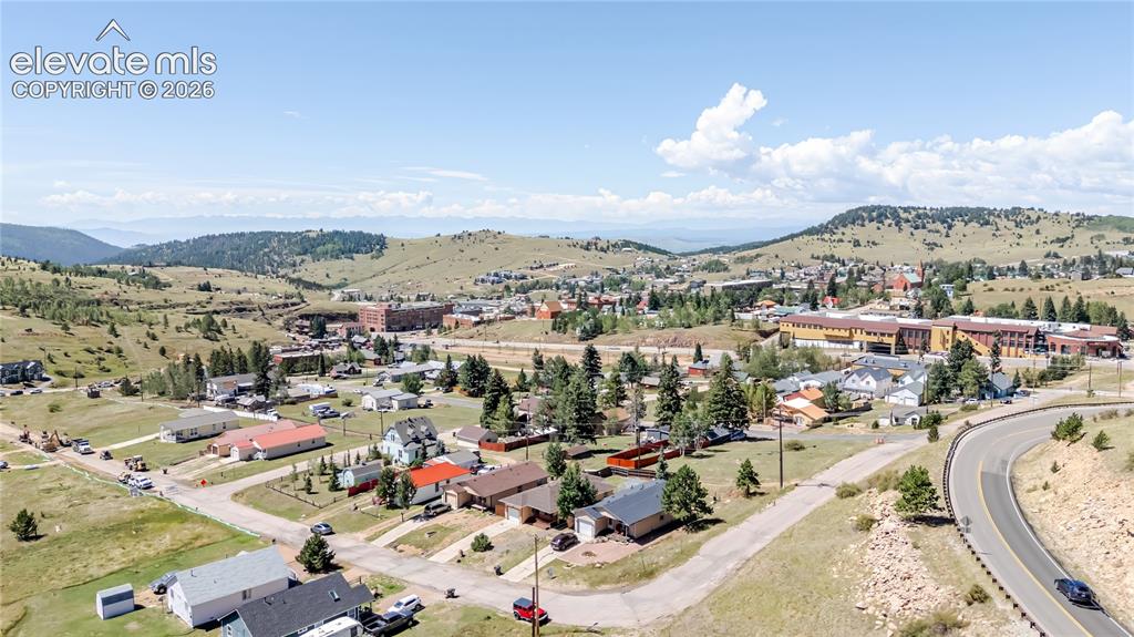 Image 9 of 27: Home in neighborhood with the city of Cripple Creek and distant mountains t