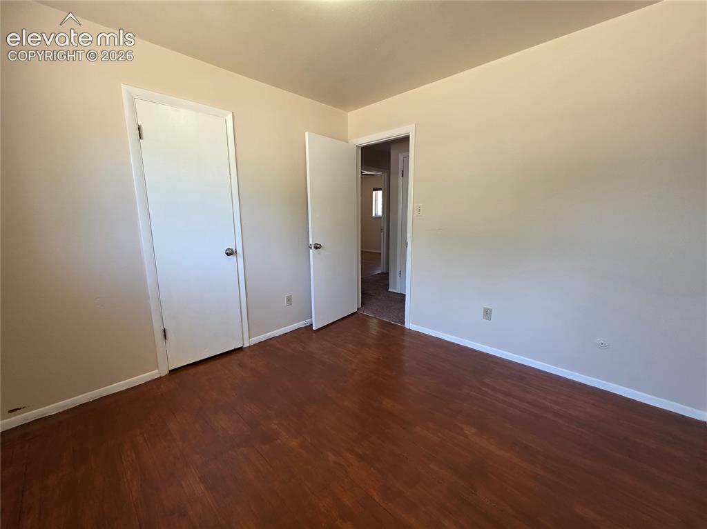 Image 11 of 17: Room featuring wood-finish flooring, light neutral wall tones, white trim,