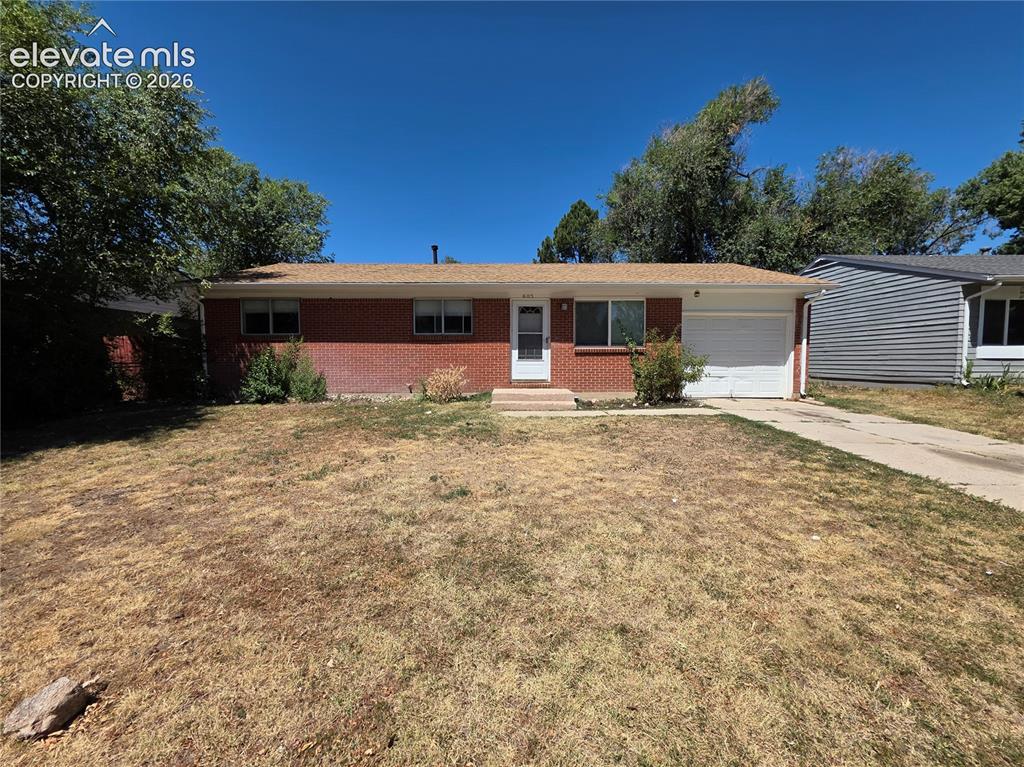 Image 2 of 17: Brick exterior home featuring a front porch entry and an attached garage wi