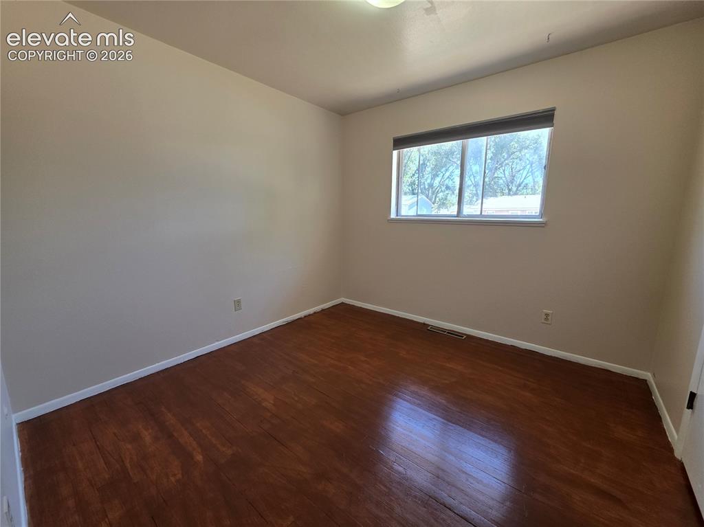 Image 9 of 17: Room featuring wood-finish flooring and neutral wall tones