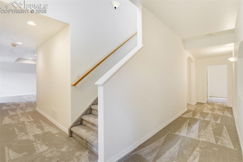 Image 33 of 50: Basement stairway and hallways leading to very open spaces!