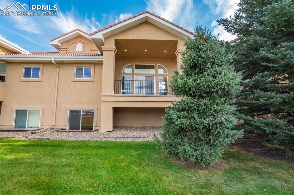 Image 45 of 50: The back of the unit with covered deck view.