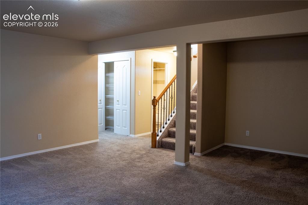 Image 22 of 40: Carpeted interior space featuring neutral wall tones, white baseboards, and